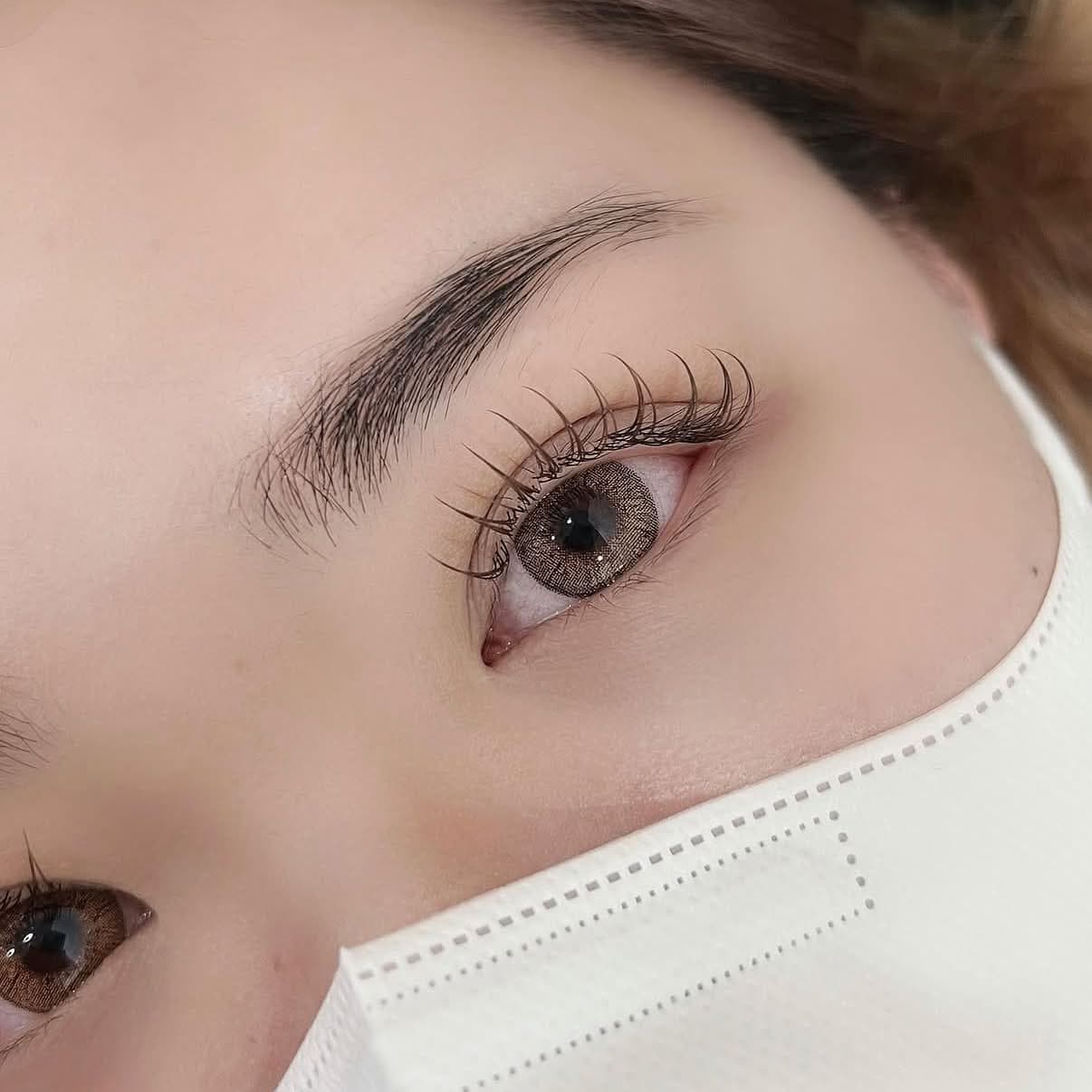 Close-up of an open eye with soft, curled lashes grouped into small points, like a fresh coat of mascara.